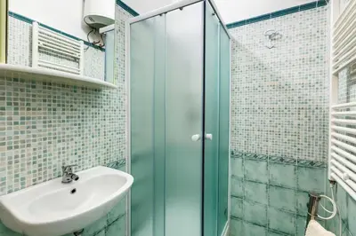 a bathroom with a glass shower and a sink at Prati House in Rome