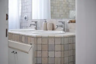 a bathroom with two sinks and a mirror at Your elegant Loft at Termini Station in Rome