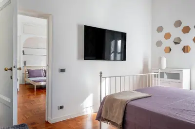 a bedroom with a bed and a tv on the wall at Your elegant Loft at Termini Station in Rome