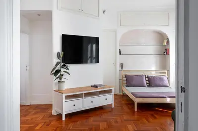 a bedroom with a bed and a tv on a wall at Your elegant Loft at Termini Station in Rome
