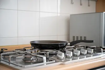 a frying pan on top of a stove in a kitchen at Your elegant Loft at Termini Station in Rome