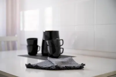 a group of black cups sitting on a kitchen counter at Your elegant Loft at Termini Station in Rome