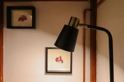 a black lamp in a room with pictures on the wall at cos24 in Rome