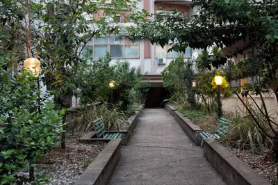a walkway in front of a building with benches at Vatican R-Home Savorelli in Rome