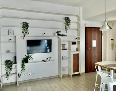 a living room with white walls and a flat screen tv at Vatican R-Home Savorelli in Rome