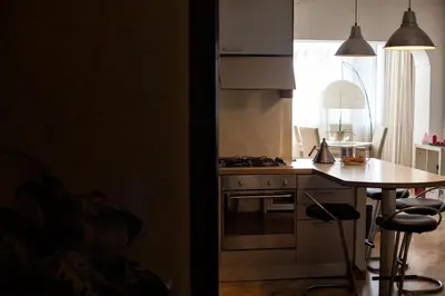 a kitchen with a table and a stove top oven at Vatican R-Home Savorelli in Rome