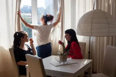 two women sitting at a table looking out a window at Vatican R-Home Savorelli in Rome