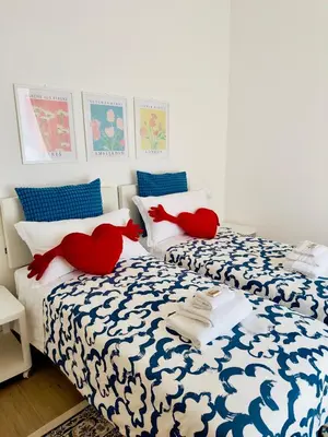 two beds with red stuffed animals on them in a bedroom at Olimpia Villa Pamphili - Centro Storico di Roma - Gianicolo Trastevere San Pietro in Rome