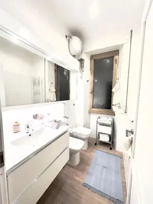 a white bathroom with a toilet and a sink at Olimpia Villa Pamphili - Centro Storico di Roma - Gianicolo Trastevere San Pietro in Rome