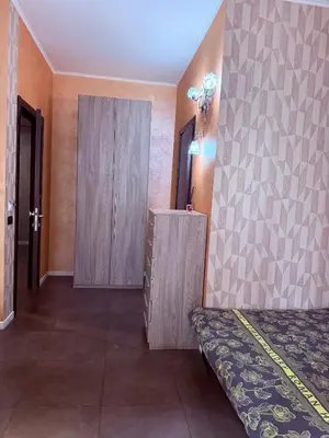 a bedroom with a bed and a cabinet and a door at B&B Roma in Rome