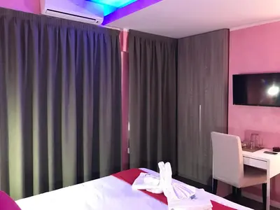 a hotel room with a bed and a desk and a sink at B&B Roma in Rome
