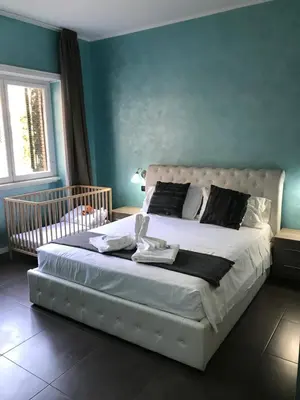 a hotel room with a bed with a desk and a television at B&B Roma in Rome