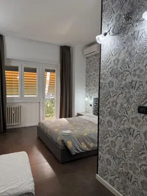a bedroom with a bed and a wall at B&B Roma in Rome