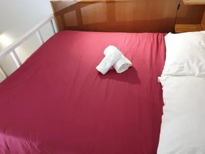 a roll of toilet paper sitting on top of a bed at Casa Manzoni in Rome