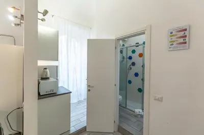 a bathroom with a shower with a glass door at Casa Manzoni in Rome