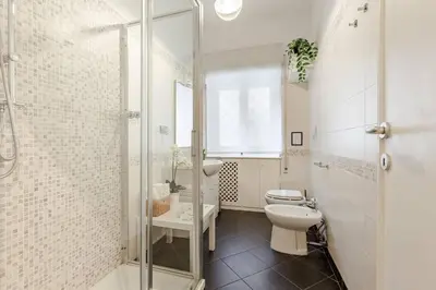 a white bathroom with a toilet and a shower at Bellina Suite at the Vatican in Rome