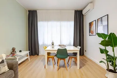 a living room with a dining room table and chairs at Bellina Suite at the Vatican in Rome