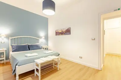a bedroom with a bed and a table in it at Bellina Suite at the Vatican in Rome