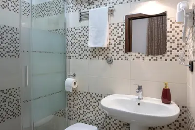 a bathroom with a sink and a glass shower at STELLA GUEST HOUSE O AFFITTACAMERE in Rome