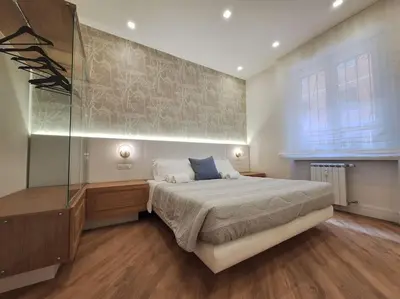 a bedroom with a large bed and a window at Peaceful 2 Bedrooms with patio, near Metro A in Rome