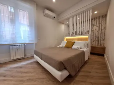 a bedroom with a large bed and a window at Peaceful 2 Bedrooms with patio, near Metro A in Rome