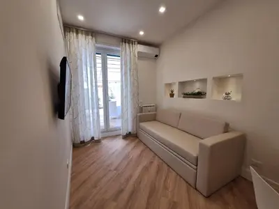 a living room with a couch and a window at Peaceful 2 Bedrooms with patio, near Metro A in Rome