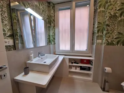 a bathroom with a sink and a mirror at Peaceful 2 Bedrooms with patio, near Metro A in Rome