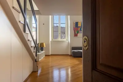 a hallway with a staircase and a living room at [Trastevere Lux* * * * *] - Roma Centro Storico in Rome
