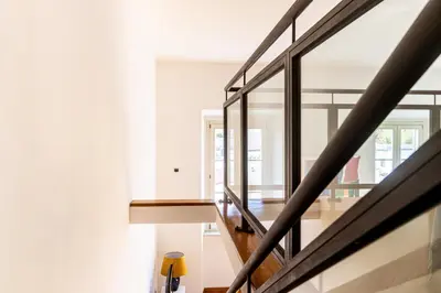 a staircase in a house with glass railing at [Trastevere Lux* * * * *] - Roma Centro Storico in Rome