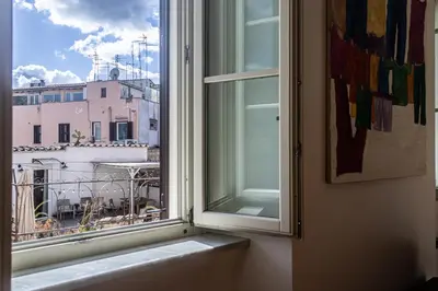 a window with a view of a building at [Trastevere Lux* * * * *] - Roma Centro Storico in Rome