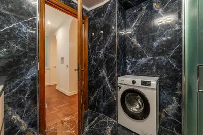 a laundry room with a washer and dryer at GuestHost - Rione Sallustiano Elegant Apartment in Rome