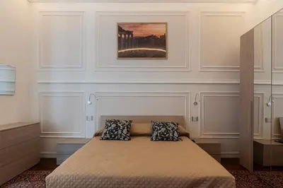 a bedroom with a bed with two pillows on it at GuestHost - Rione Sallustiano Elegant Apartment in Rome