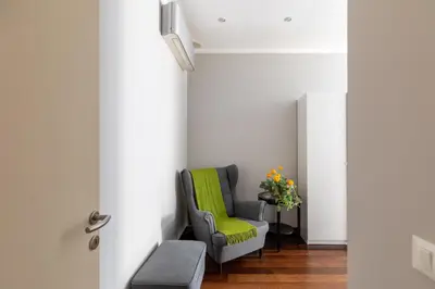 a room with a green chair and a table at iFlat Contemporary Elegance in the heart of Rome in Rome