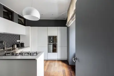a kitchen with white counters and a stove top oven at iFlat Contemporary Elegance in the heart of Rome in Rome