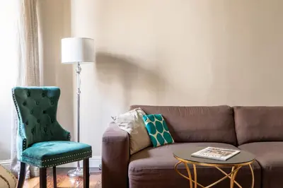 a living room with a brown couch and a green chair at iFlat Contemporary Elegance in the heart of Rome in Rome