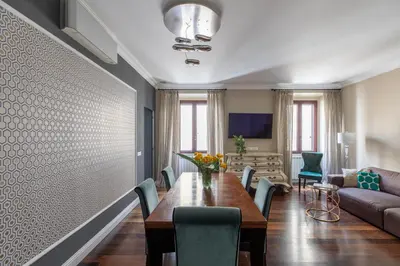 a dining room with a table and chairs and a couch at iFlat Contemporary Elegance in the heart of Rome in Rome