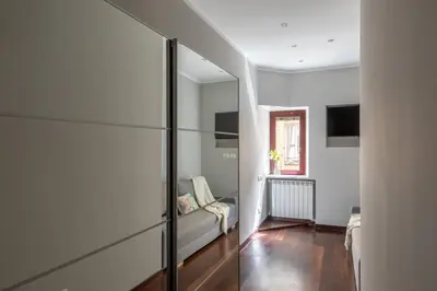 a living room with a couch and a glass wall at iFlat Contemporary Elegance in the heart of Rome in Rome