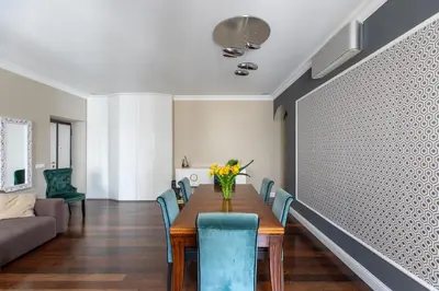 a dining room with a table and blue chairs at iFlat Contemporary Elegance in the heart of Rome in Rome