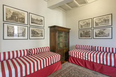 a living room with two red and white couches at Pantheon Palazzo Nari Terrace #12 in Rome