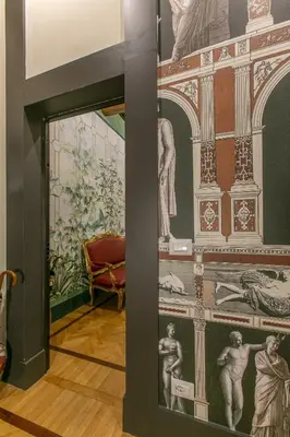 a room with a wall with paintings on it at Pantheon Palazzo Nari Terrace #12 in Rome