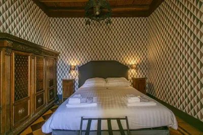 a bedroom with a large bed with two stools in it at Pantheon Palazzo Nari Terrace #12 in Rome