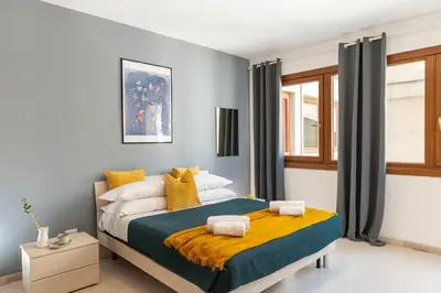 a bedroom with a bed with yellow and blue at San Paolo Home in Rome
