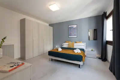 a bedroom with a bed and a blue wall at San Paolo Home in Rome