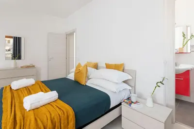 a bedroom with a bed with towels on it at San Paolo Home in Rome
