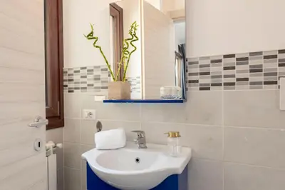 a bathroom with a sink and a mirror at San Paolo Home in Rome