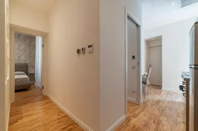 a hallway with a door leading into a living room at GuestHost - Rome Huge & Cozy Apartment in Rome
