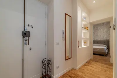 a hallway with a door leading to a bedroom at GuestHost - Rome Huge & Cozy Apartment in Rome