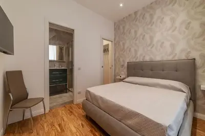 a bedroom with a bed and a chair at GuestHost - Rome Huge & Cozy Apartment in Rome