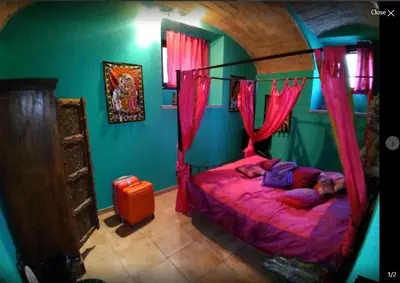 a bedroom with a bed with pink drapes at Shiva B&B in Rome
