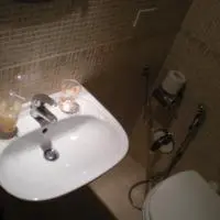 a bathroom with a white sink and a toilet at Shiva B&B in Rome